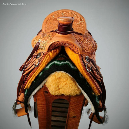 Front view of Carved saddle sitting on saddle tree 