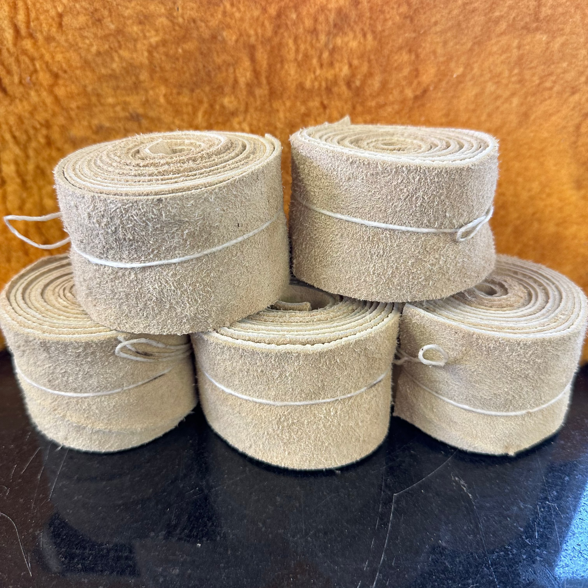 Elk hide rolls on black tale with yellow backdrop