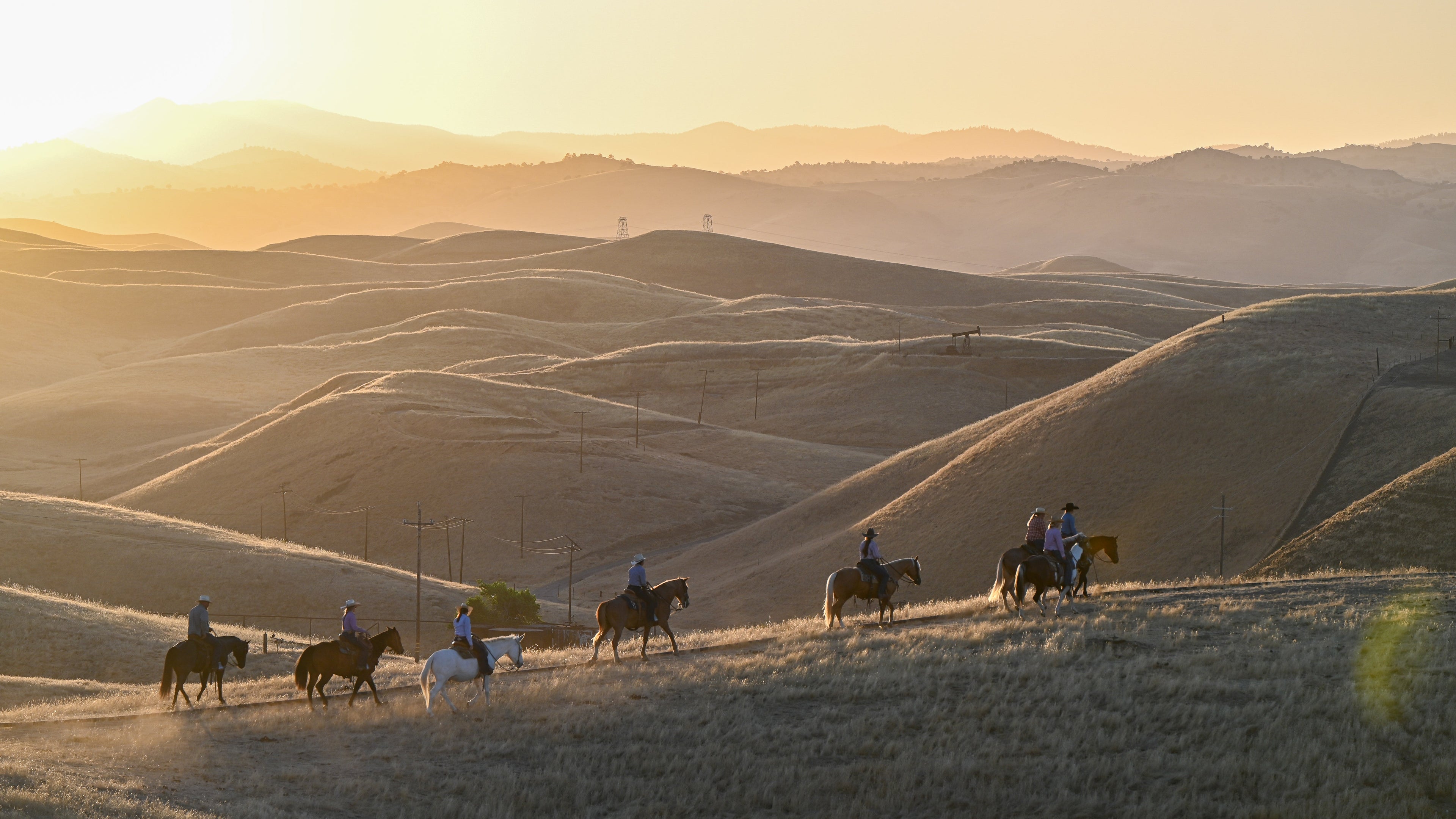 Riders riding on a hilltop