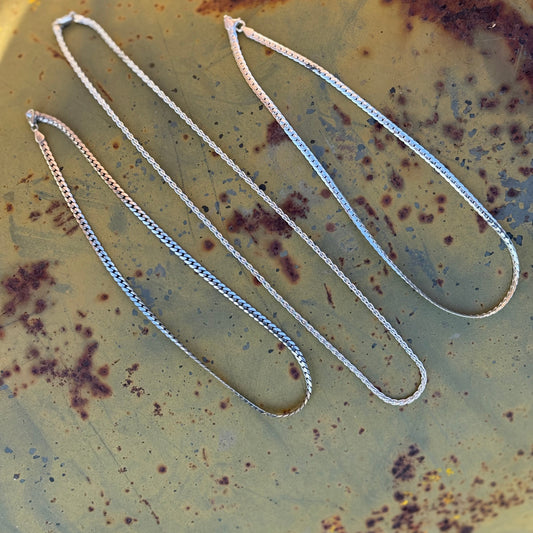 Silver chain on a rusty metal surface
